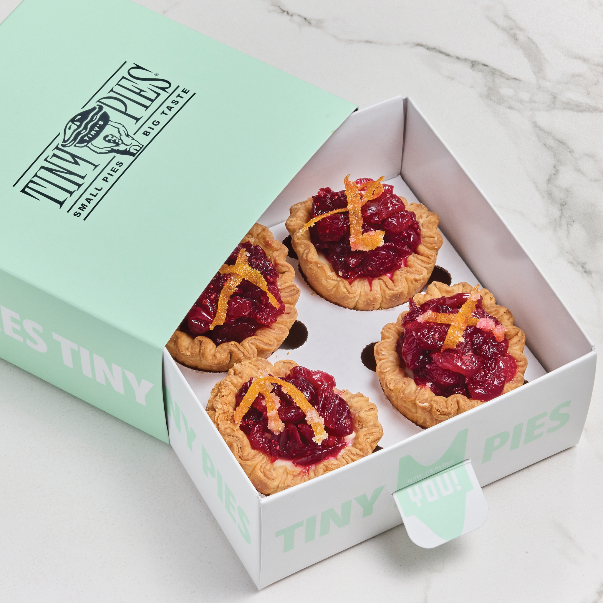 Cranberry Orange mini cheesecakes in a mint green gift box